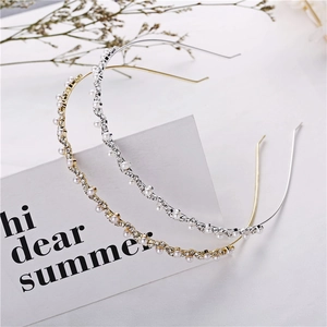 Detail of wavy gold and silver metal headbands featuring faux pearls and rhinestones