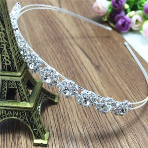 Close-up of silver metal headband with seven sparkling rhinestone sunflower patterns