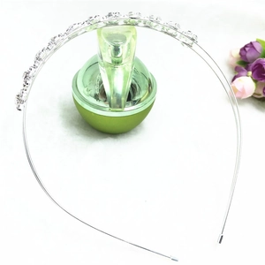 Detailed close-up of a silver sunflower headband with sparkling rhinestones on faux fur