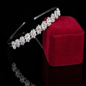 Elegant silver tiara headband with sunflower rhinestones on a red velvet jewelry box