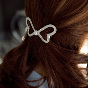 Barrette à cheveux élégante avec nœud et strass blancs sur cheveux châtain foncé