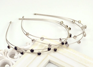 Close-up of double-layer metal headbands with sparkling rhinestones and crystal details