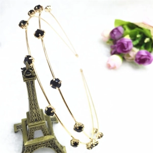 Detail of double-layer gold metal headband with black crystal rhinestones in vintage style