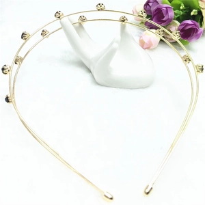 Close-up of double-layer gold metal headband featuring claw-set dark crystal rhinestones