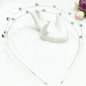 Detail view of double-layer silver alloy headband with sparkling rhinestones on white base