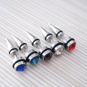 Detailed macro view of punk style stainless steel spike earrings with colorful crystals