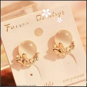 Macro view of leopard print stud earring featuring warm white opal and gold rhinestones