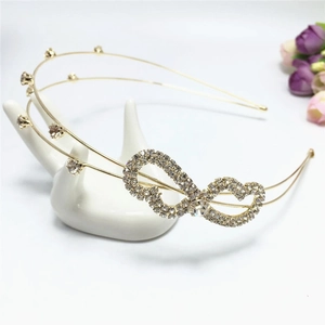 Close-up of golden double-layer headband featuring infinity rhinestone ornament and crystals