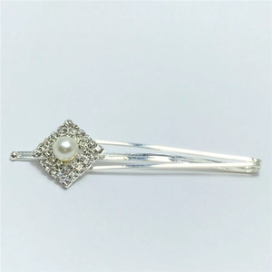 Détail de la barrette argentée ornée de strass brillants et d'une perle blanche centrale