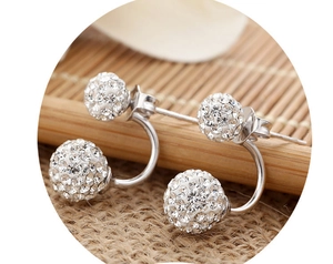 Macro view of double Shamballa stud earrings with pave-set rhinestones and silver finish