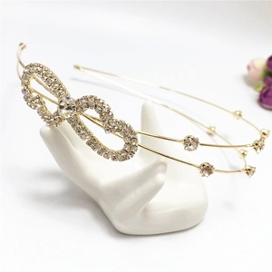 Detail of elegant gold double-layered headband featuring sparkling rhinestone heart motifs