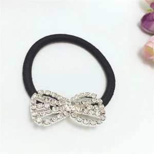 Macro detail of high-elastic black hair tie featuring a sparkling rhinestone bow accessory