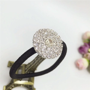 Detail of elegant black hair tie featuring a sparkling circular rhinestone crystal motif