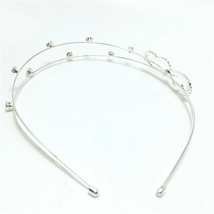 Detail of silver double-row rhinestone headband featuring heart-shaped cutout elements