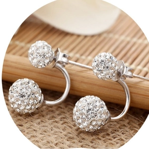 Silver Shamballa crystal ball jacket earrings with pavé rhinestones on burlap background