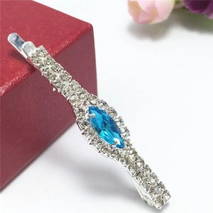 Detailed close-up of blue marquise rhinestone hair clip with silver crystal inlay