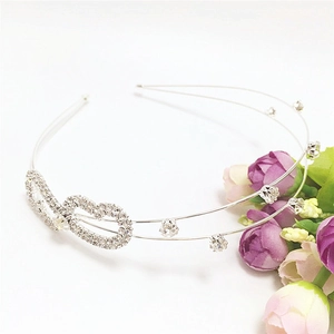 Detail of silver double-layered headband with sparkling rhinestones and bow accent