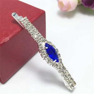 Macro shot of silver hair clip with navy blue crystal and white rhinestones decoration