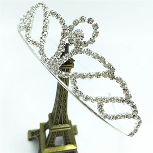 Elegant silver bridal tiara with rhinestones and hollow patterns on Eiffel Tower stand