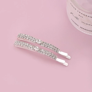 Sparkling crystal rhinestone hair clips in silver finish on soft pink background