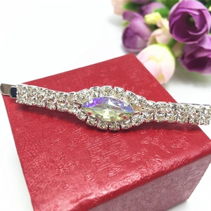 Macro view of silver barrette with AB rhinestone crystal on a red jewelry gift box