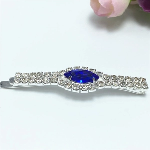 Elegant silver hair clip featuring rows of rhinestones and a central blue marquise gem