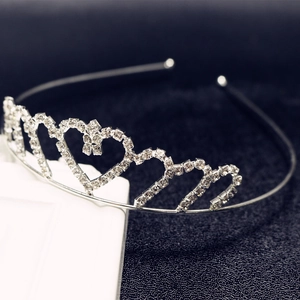 Detailed macro view of heart-shaped silver bridal tiara with sparkling crystal rhinestones