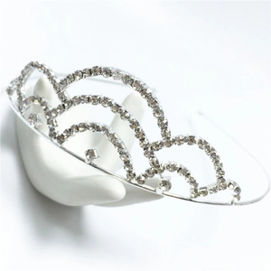 Detailed close-up of a silver crown headband with layered crystal rhinestones
