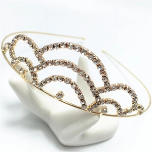 Elegant gold rhinestone crown headband for bridal or party wear on white display