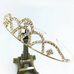 Detail of a sparkling bridal crown headband with clear rhinestones on a gold frame