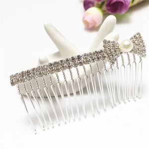 Elegant silver hair comb featuring sparkling crystals, a bow design, and a pearl accent