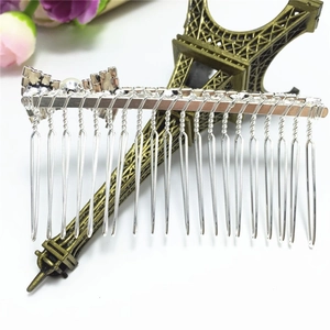 Silver metal hair comb with crystal bow design and twenty teeth for bridal styling
