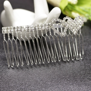 Detailed view of silver rhinestone hair comb featuring elegant double heart design