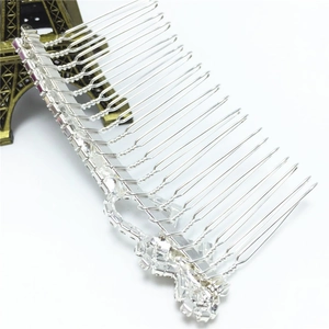 Detail of silver alloy hair comb with sparkling white and purple rhinestones