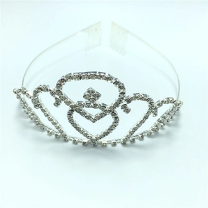 Detailed view of silver heart crown tiara with sparkling crystals and metal comb teeth