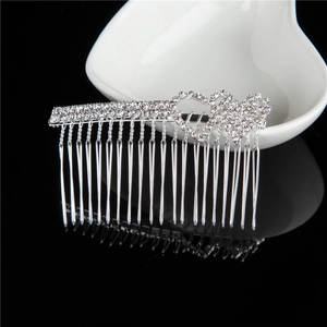 Silver double heart hair comb with rhinestones on a reflective black background