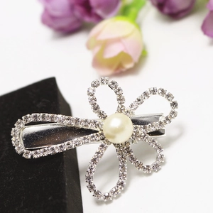 Elegant silver flower hair clip with sparkling rhinestones and center pearl on white background
