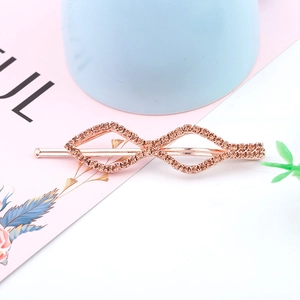 Detailed macro view of geometric rose gold hair clip with sparkling rhinestones decoration
