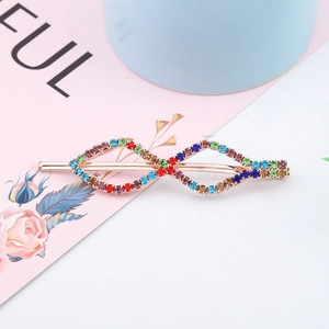 Infinity shape hair clip with multi-color gradient rhinestones on golden metal base