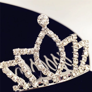Elegant silver crown hair comb with white rhinestones on dark blue velvet