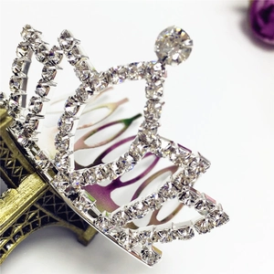 Macro shot of silver alloy tiara hair comb with sparkling white rhinestones and zircon