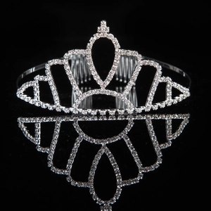 Elegant silver tiara with sparkling rhinestones and hair combs on a black background