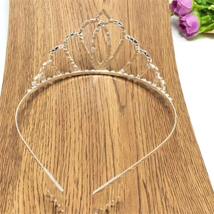 Detailed view of silver heart crown tiara with sparkling rhinestones and secure hair combs