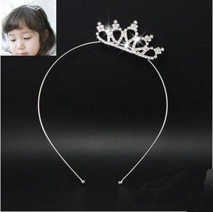 Detail showing crystal-encrusted silver tiara headband for children's parties
