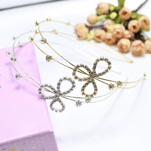 Close-up of gold and silver rhinestone bow headbands with sparkling crystal details
