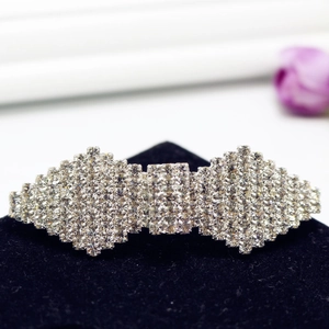 Sparkling rhinestone geometric bow hair clip with silver finish on black velvet display