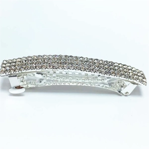Detail view of the four-row crystal rhinestone inlay on a silver metal spring hair clip
