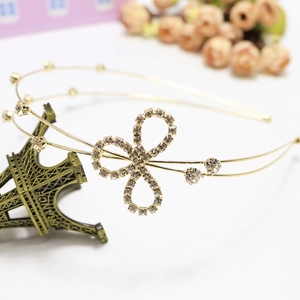 Elegant gold double-layered rhinestone headband with a delicate sparkling bow accent