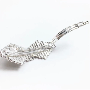 Detailed view of silver leaf-shaped metal hair clip with intricate rhinestone texture