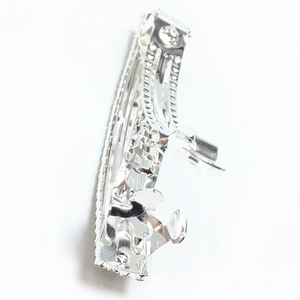 Detail view of the silver metal spring hair clip mechanical structure and closure